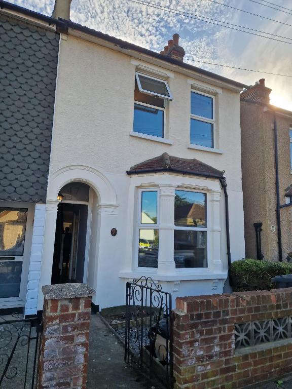 a white house with a gate in front of it at Dartford Haven in Dartford