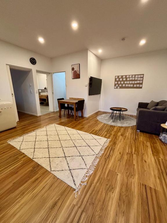 a living room with a couch and a table at LA-Hüttenfeld Erdgeschoss Apartment in Lampertheim