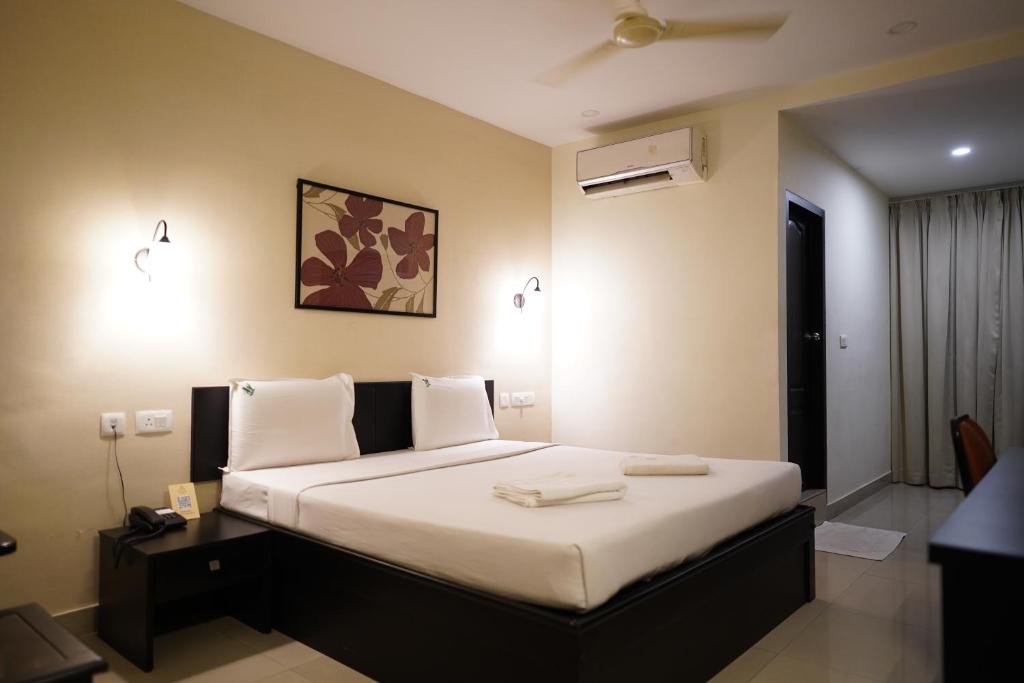 Ένα ή περισσότερα κρεβάτια σε δωμάτιο στο Wynad Hotel