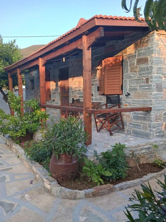a house with a wooden roof and a patio at Vasilis Studios in Animborió