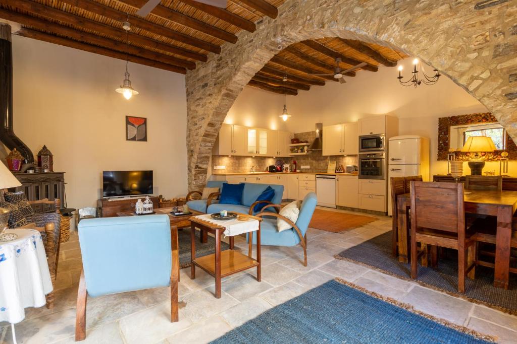 a kitchen and living room with a table and chairs at Villa Monti Cozy Yard & BBQ Perfect for Families & Friends in Kato Lefkara