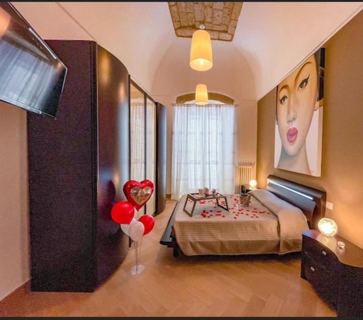 a bedroom with a bed with red balloons in it at Ancaranvs B&B in Bitonto