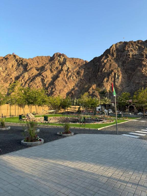 a stone walkway with a mountain in the background at Daftah Valley Farmhouse in Daftah