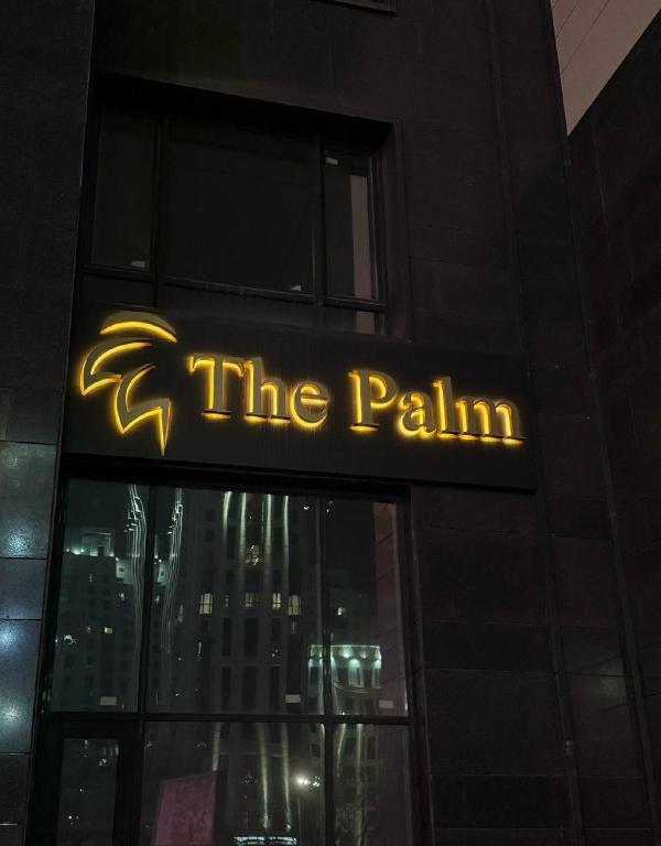a sign on a building that says the painin at The Palm hotel & spa in Almaty
