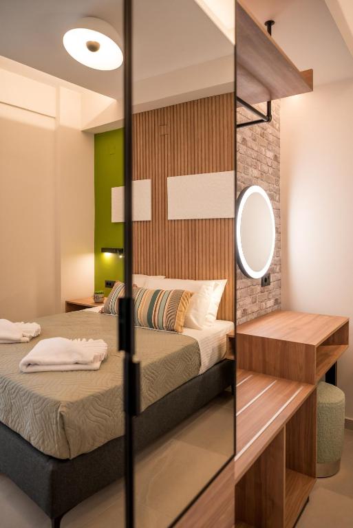 a bedroom with two beds and a mirror at Chania Experience Residence in Chania