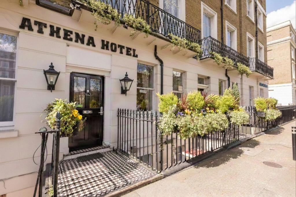 a hotel with flowers on the front of a building at Athena Hotel in London