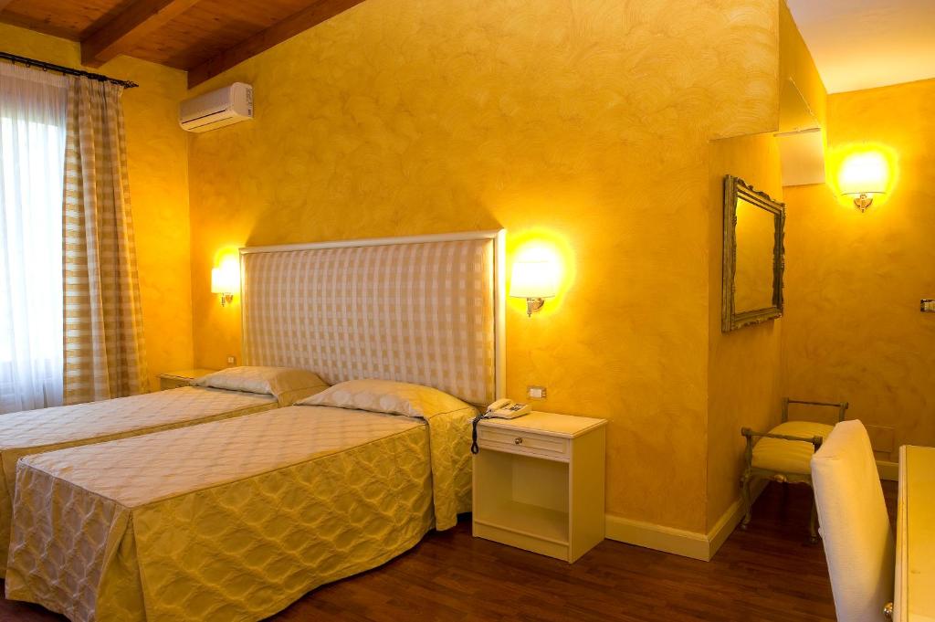 Voodi või voodid majutusasutuse Park Hotel Villaferrata toas