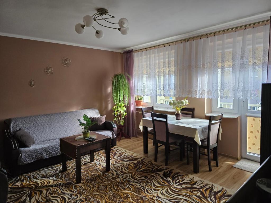 a living room with a couch and a table at Centrum Jagoda in Pisz