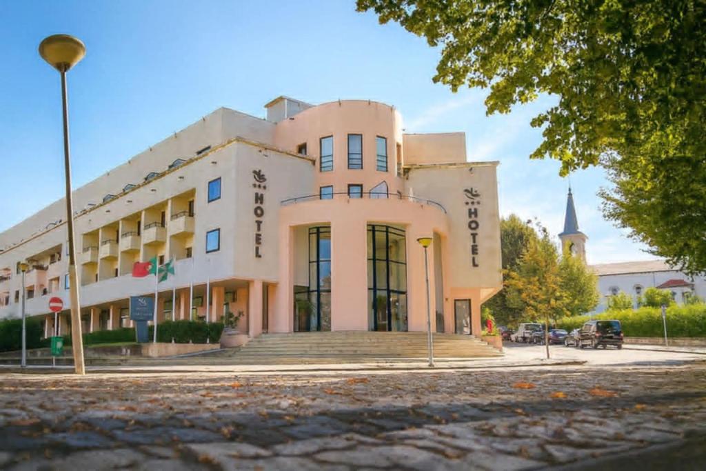 a large white building on a street at Hotel das Taipas in Guimarães