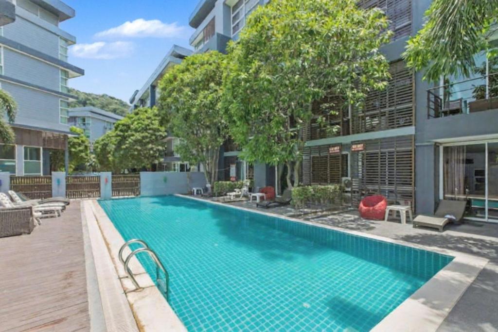 an image of a swimming pool in a building at Kris - Modern Spacious 2 Bedrooms Condo with Pool in Patong Beach