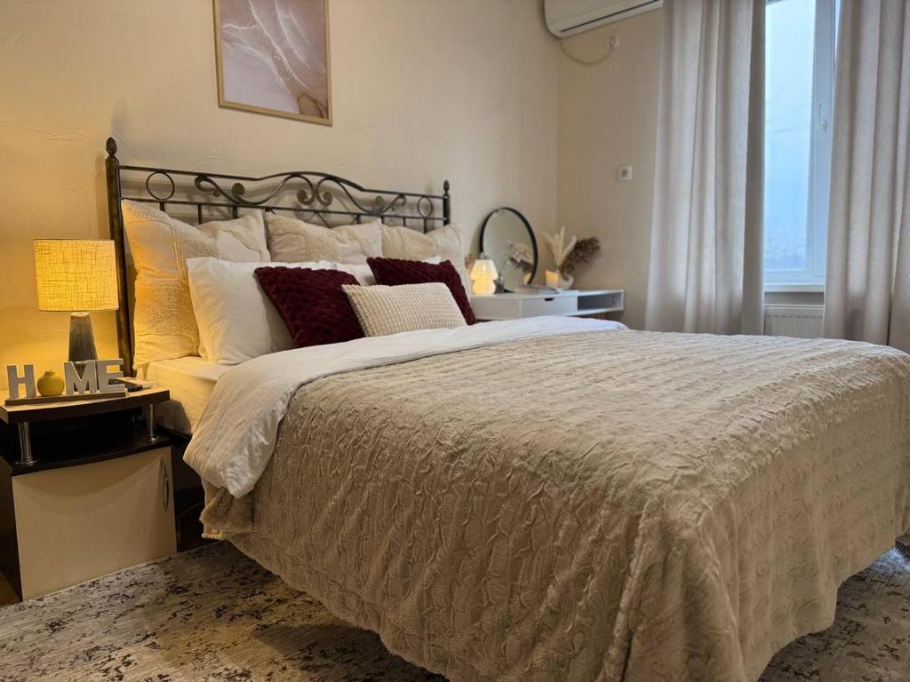 a bedroom with a large bed and a window at Home Boutique Hotel in Chişinău