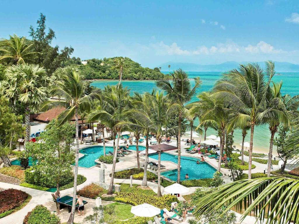 an aerial view of a resort with a pool and the ocean at ibis Samui Bophut Hotel in Bophut 