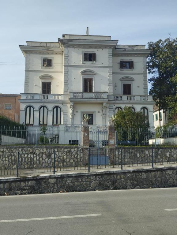 a white house with a fence in front of it at Villa Santoni Guest House Orte Home Sweet Home Viterbo in Orte