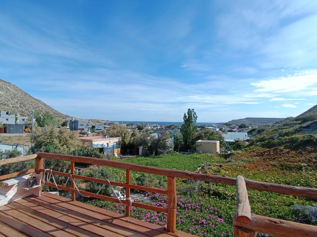 a wooden bench sitting on top of a hill at Cabaña del Mirador 5 in Puerto Pirámides