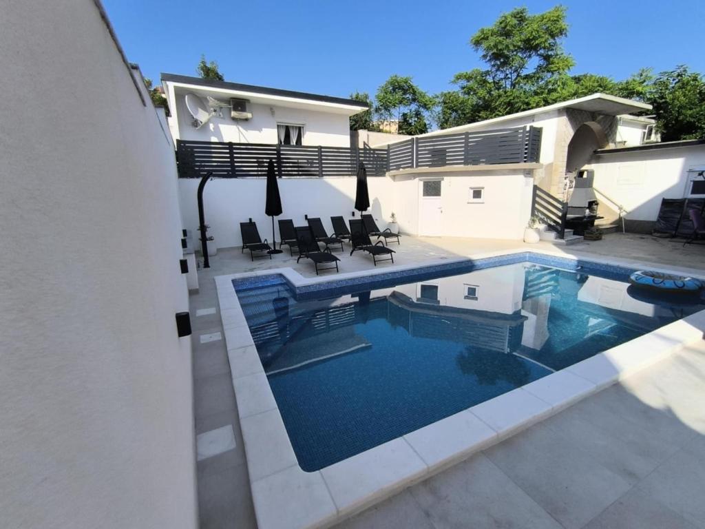 una piscina nel cortile di una casa di Apartmani Evica - App 1 a Crikvenica