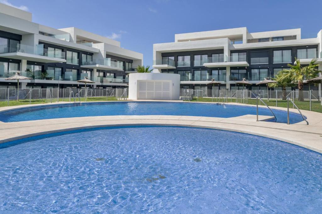 a large swimming pool in front of a building at Atico de Lux Zahara in Zahara de los Atunes