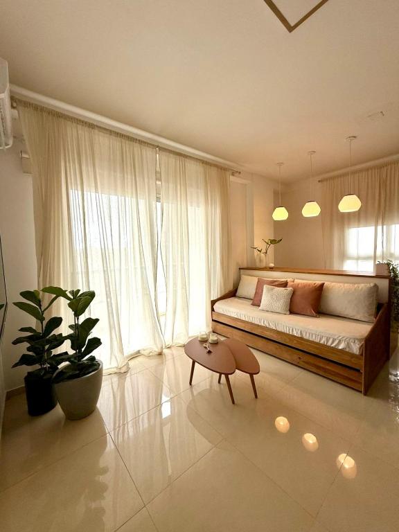 a bedroom with a large bed and a table at Capibara 6 - Vistas de Junin in Corrientes