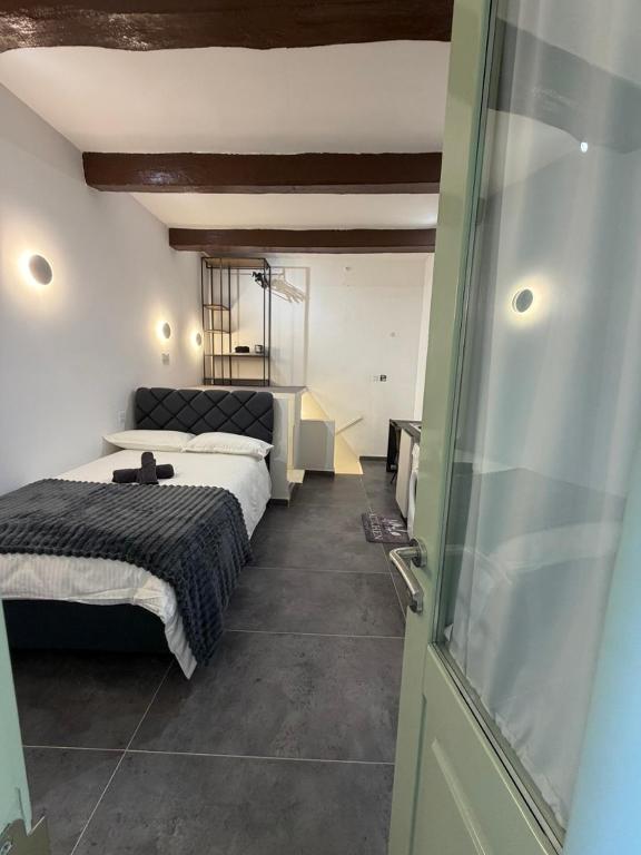 a bedroom with two beds and a sliding glass door at 3 St Anne's Street in Valletta