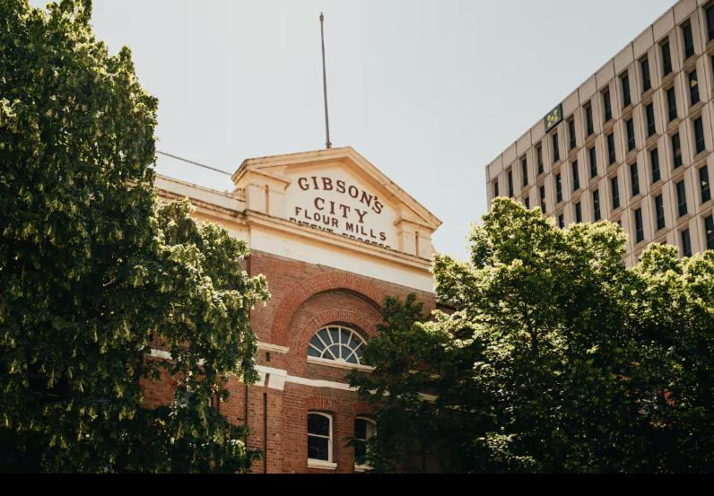 a sign on the side of a brick building at Gibson Mill Penthouse with private balcony - 301 in Hobart