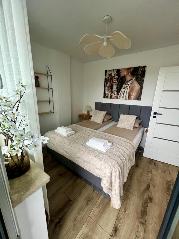 a bedroom with a bed and a ceiling fan at SPV Rentals Pileckiego 59 lokal 258 free Parking Ursynów in Warsaw