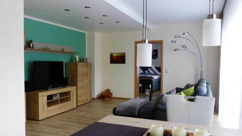 a living room with a couch and a television at Fewo Rheinwein 1 "ausgezeichnet zum wandern und radfahren" mit Wallbox in Boppard