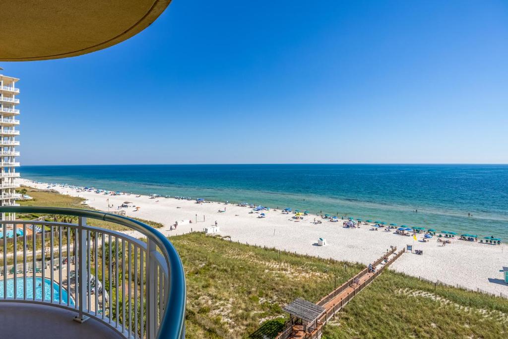 a view of a beach with people in the water at Beach Colony Tower 7A By Pkrm in Pensacola