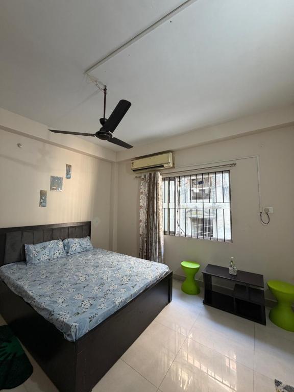 a bedroom with a bed and a window at Da Nest in Guwahati