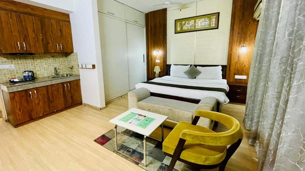 a hotel room with a bed and a table in it at Hotel Four Season - Gomtinagar - Lucknow in Lucknow