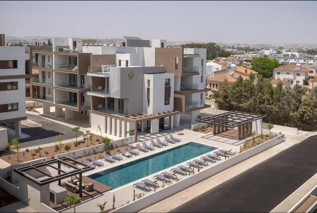an aerial view of a building with a swimming pool at Kalamon Luxury Suite 105 w Pool & Gym in Livadhia