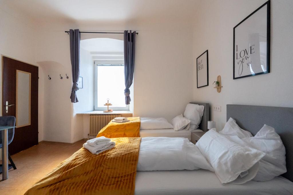 a bedroom with two beds and a window at Quiet Studio - 2 Single Beds - Central - Netflix in Leoben