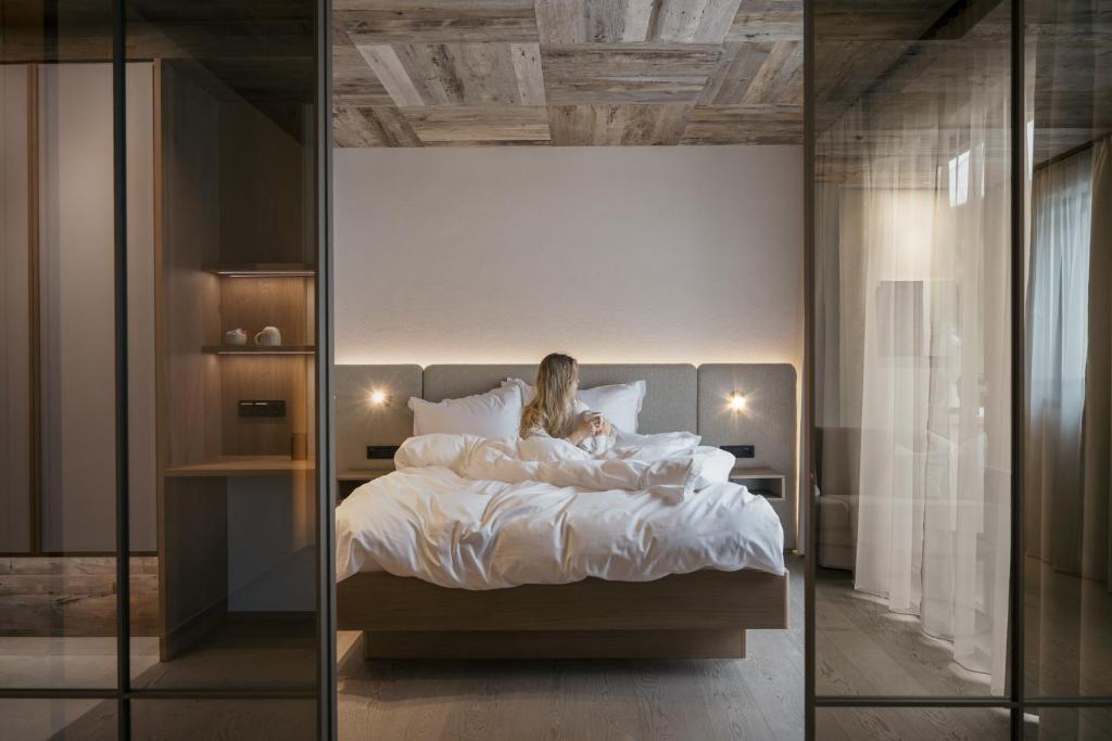 a woman laying in bed in a bedroom at Alpvita Piz Tasna in Ischgl