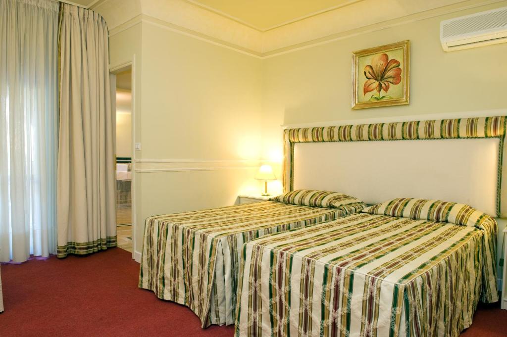 Voodi või voodid majutusasutuse Park Hotel Villaferrata toas