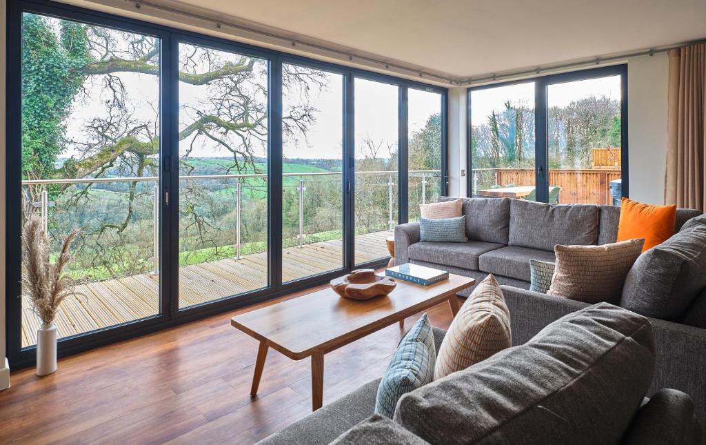 a living room with a couch and a table at The Mole Resort - Lodges in Chittlehamholt