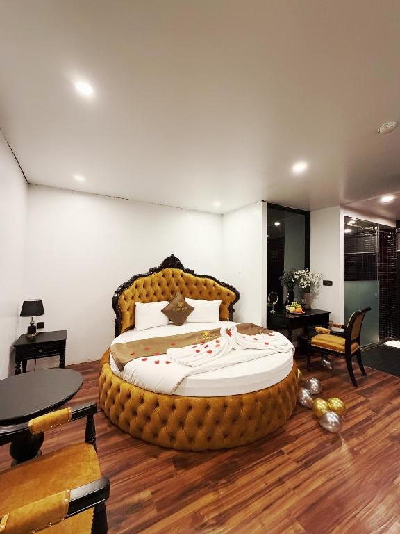 a bedroom with a large bed in the middle at Golden Hotel in Hanoi