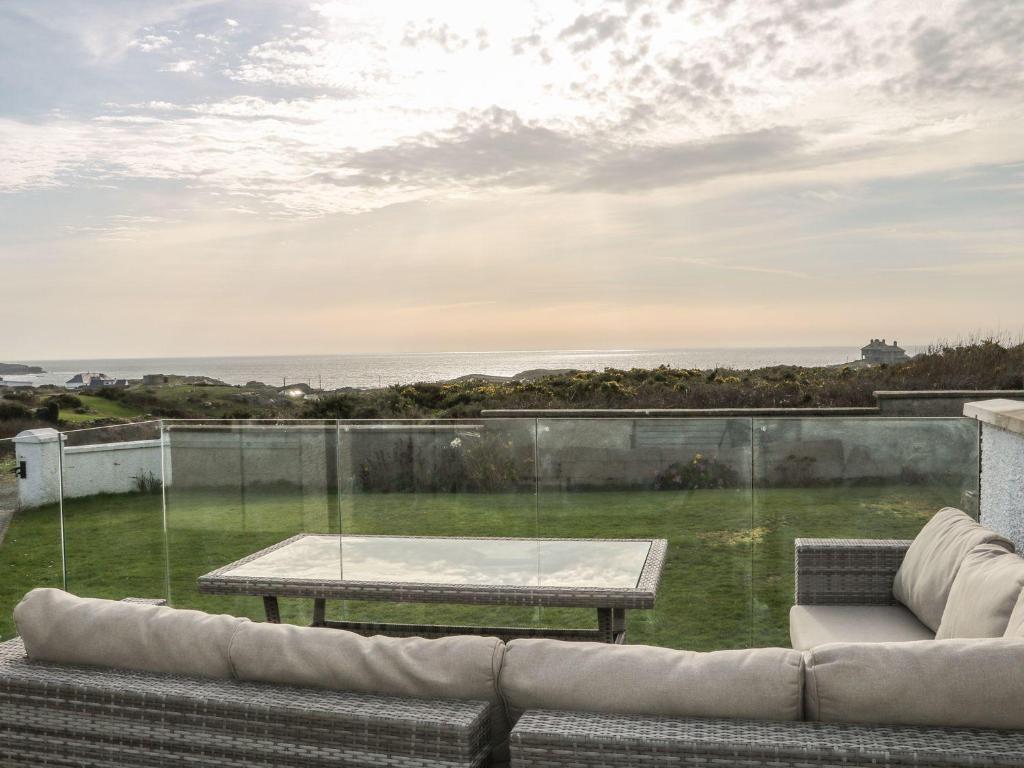 a living room with a couch and a table at Dunholme in Holyhead