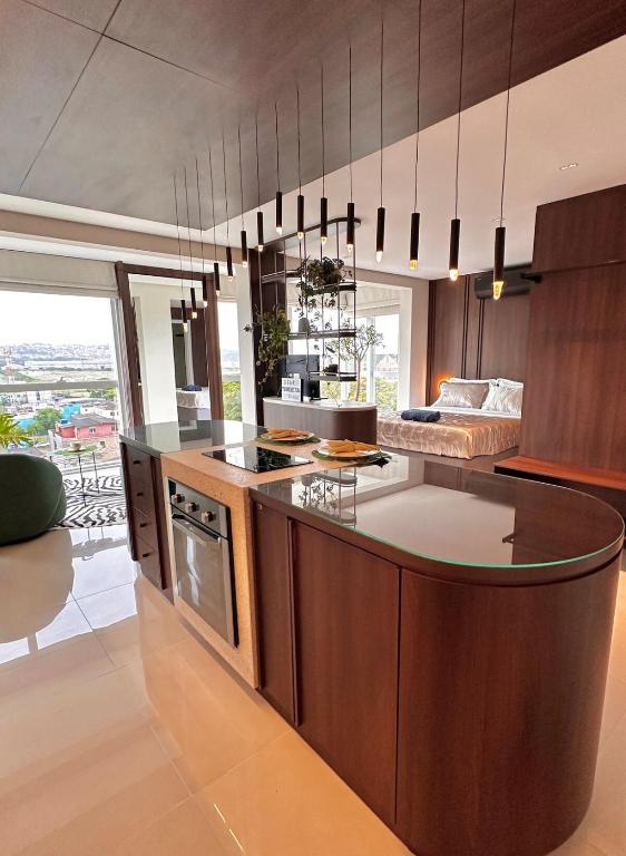 a kitchen with a large island in the middle at Studio New York in Imbituba