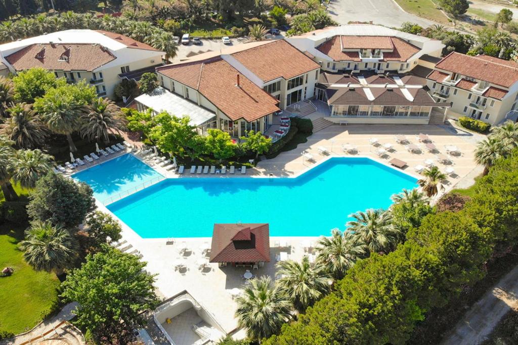 an aerial view of a house with a swimming pool at Lycus River Thermal Hotel in Pamukkale