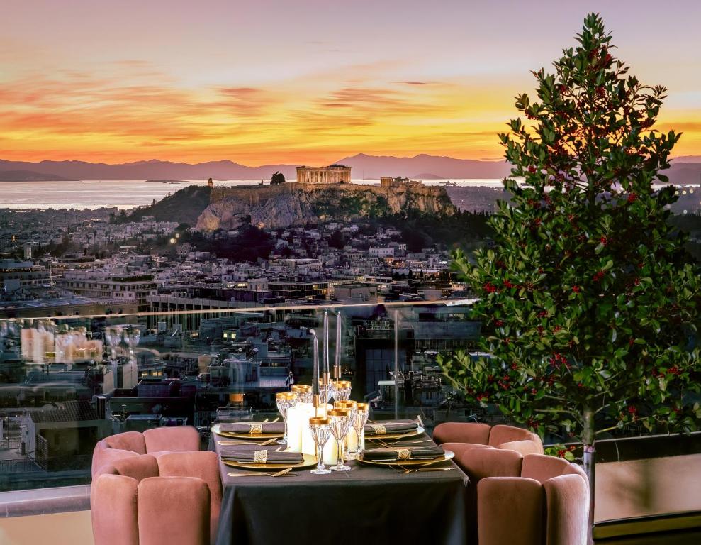 a table with a christmas tree and a view ofhens at St George Lycabettus Lifestyle Hotel in Athens