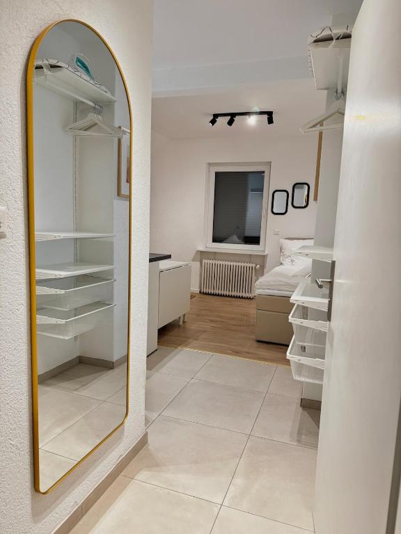 a dressing room with a mirror and a bedroom at Studio D'or in Grenchen