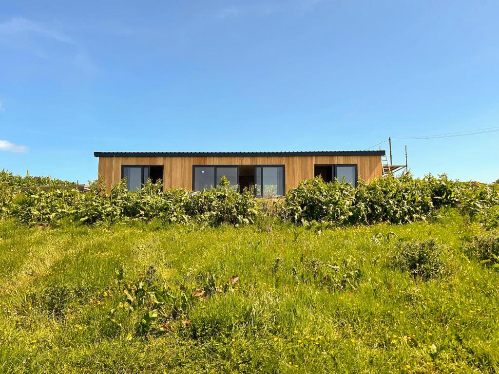 a house on top of a hill with a green field at High Tide - Uk44283 in Gatehouse of Fleet
