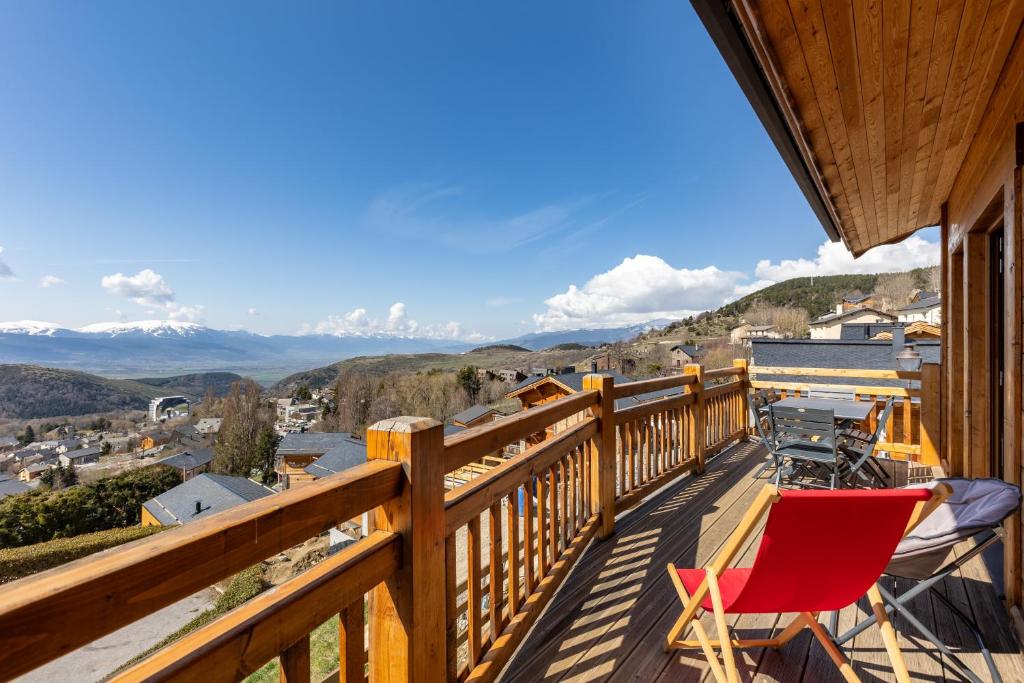 Chalet Serra Del Cadi - Vue montagne في فون-رومو-أوديللو-فيا: شرفة بها كرسي أحمر وإطلالة