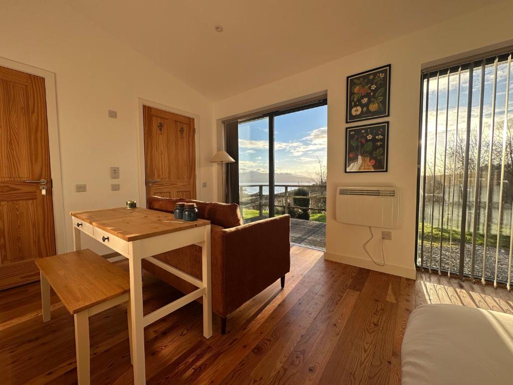 a living room with a table and a couch at Speuran Mora in Saasaig