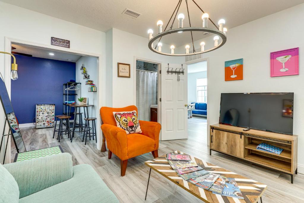 a living room with a couch and a tv at 2 Mi to Dtwn Jax Game-Ready Retreat with Yard in Springfield