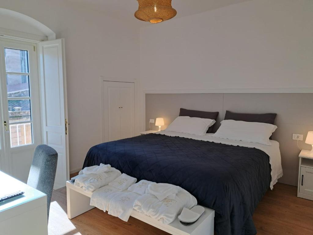 a bedroom with a large bed with towels on it at Antica Dimora Petito Luxury Suites in Matera