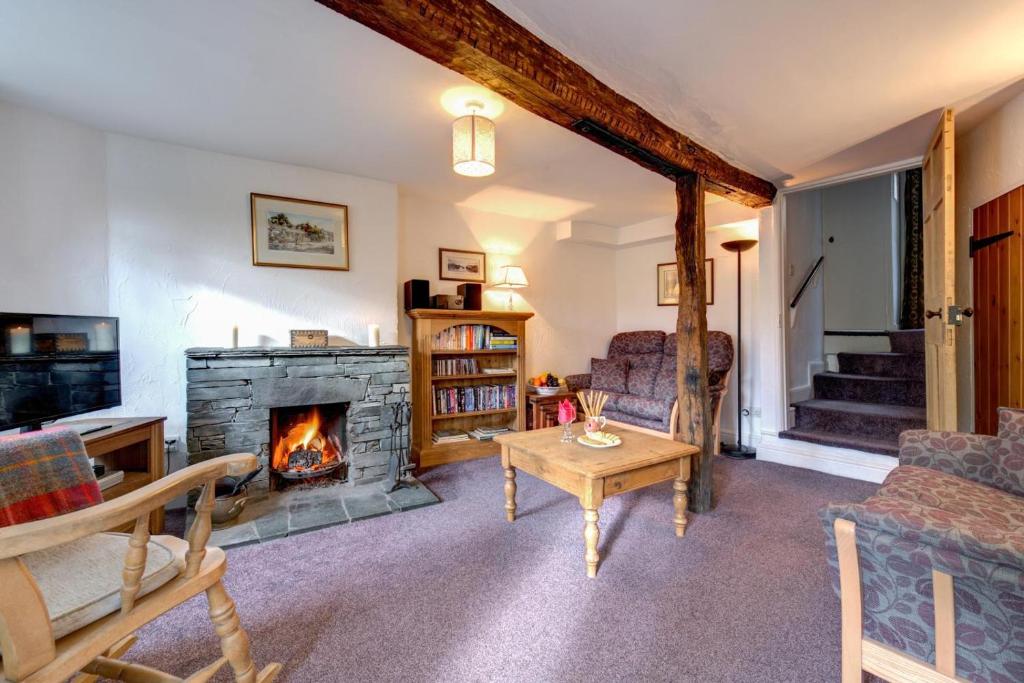 a living room with a fireplace and a couch at 2 Bed in Elterwater oc-gl004 in Chapel Stile