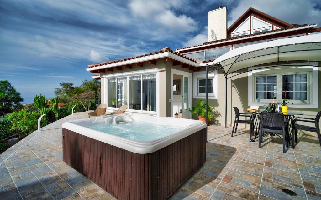 a large bath tub sitting on top of a patio at Villa Hibisco by Villas Vista Gomera in Adeje