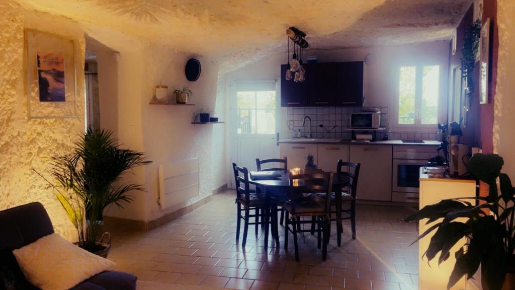 a kitchen and dining room with a table and chairs at "Ninho de Amor" troglodyte unique in Montrichard