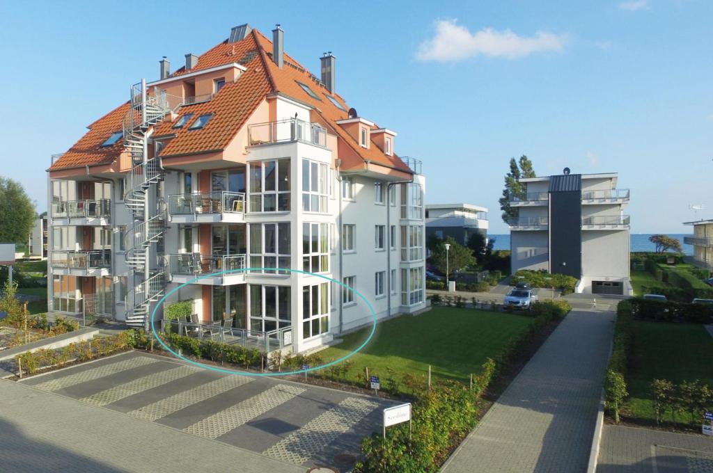 a large white building with a red roof at Seedüne 1 in Großenbrode