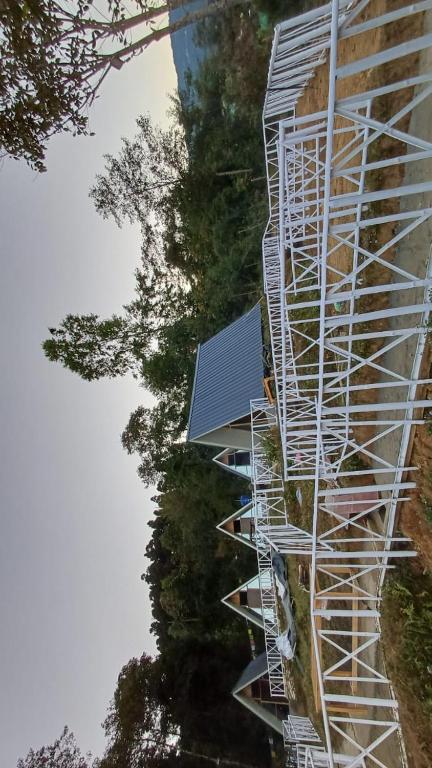 a white building with a solar panel on the side of it at Cinchonna Farmstay in Darjeeling