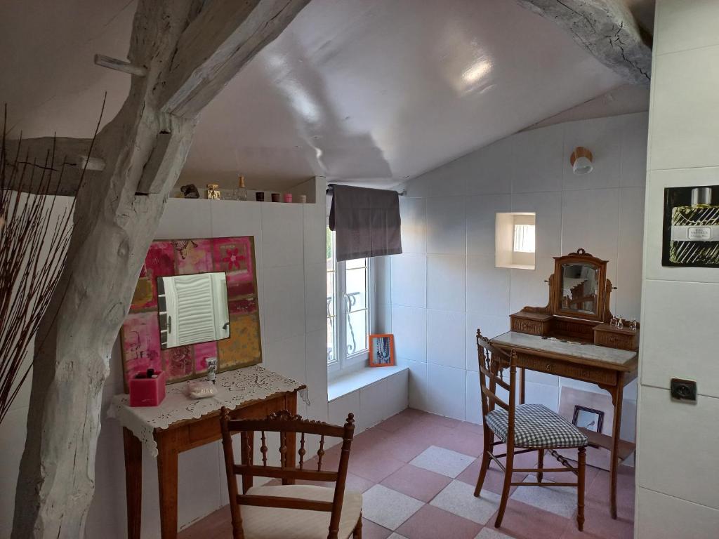 a room with a desk and a table and chairs at Les Hirondelles in Saint-Georges-sur-Layon